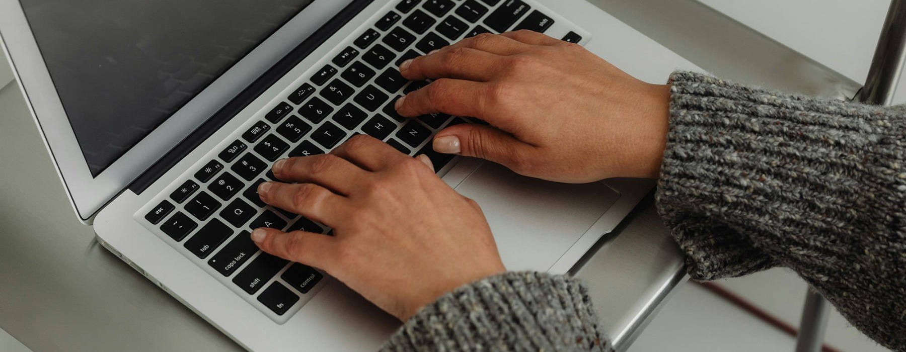 A person typing on a laptop.