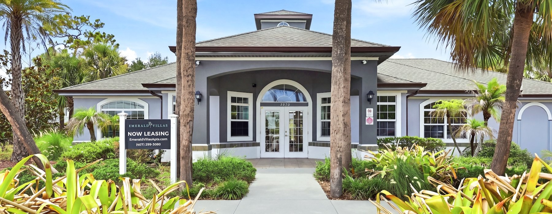 a white house with palm trees