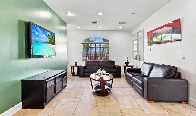 a living room with a tv and couches
